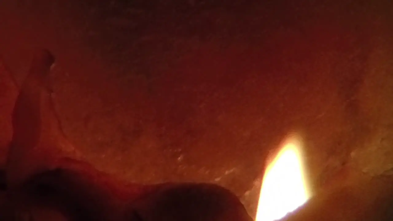 SLOW MOTION Lit Candle close up burning in the dark