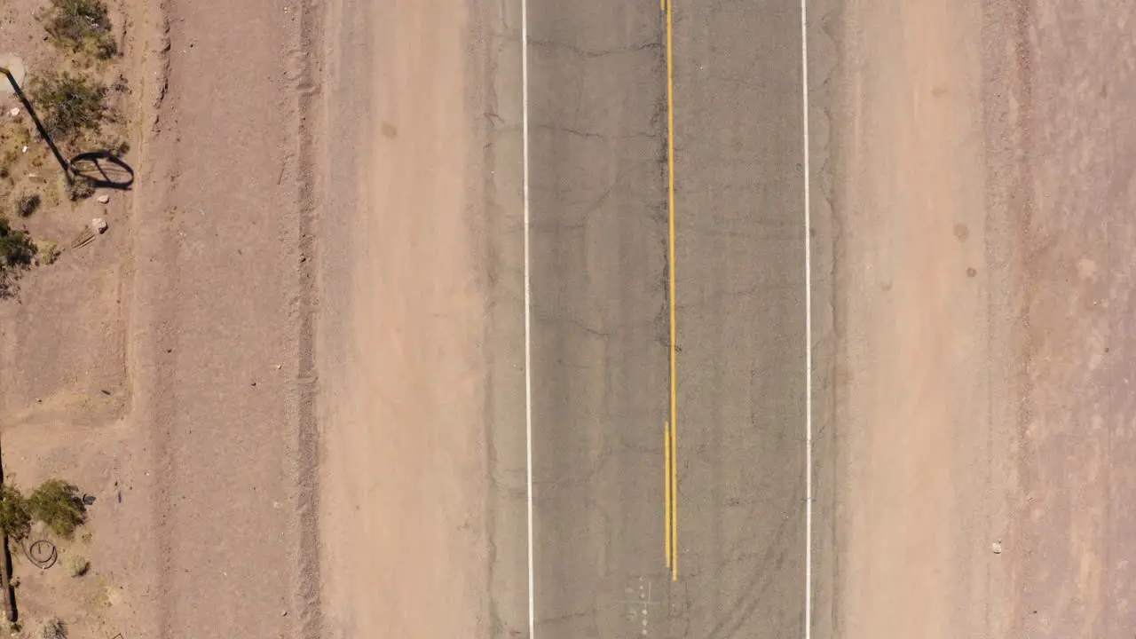 Black SUV drives down narrow part of Route 66 in California USA daytime