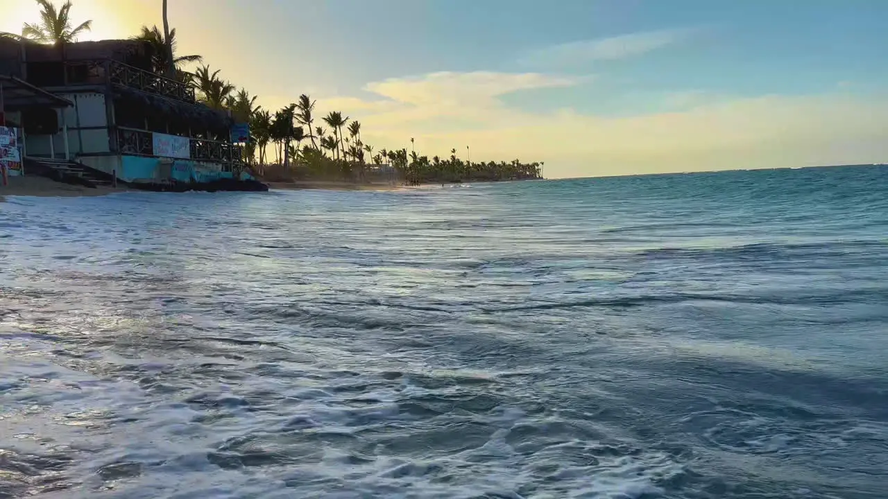 panning shot from seaside beach vendors to the ocean's breaking waves in Punta Cana Dominican Hispaniola