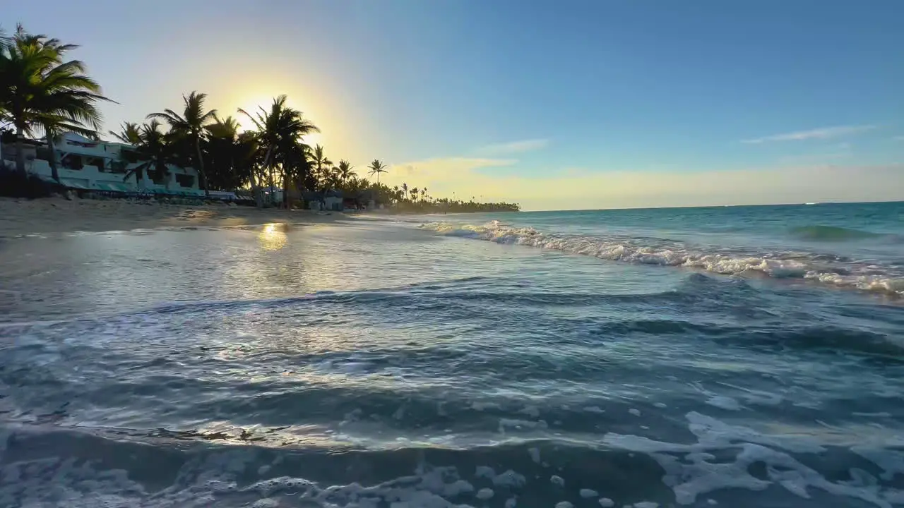 waves rolling onto a sandy beach in Punta Cana Dominican at sunset