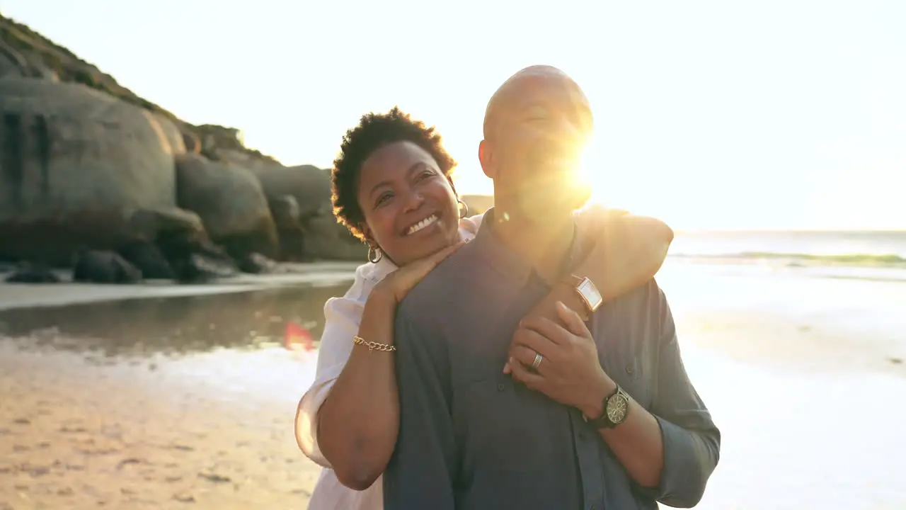 Happy couple embrace or hug with smile on beach