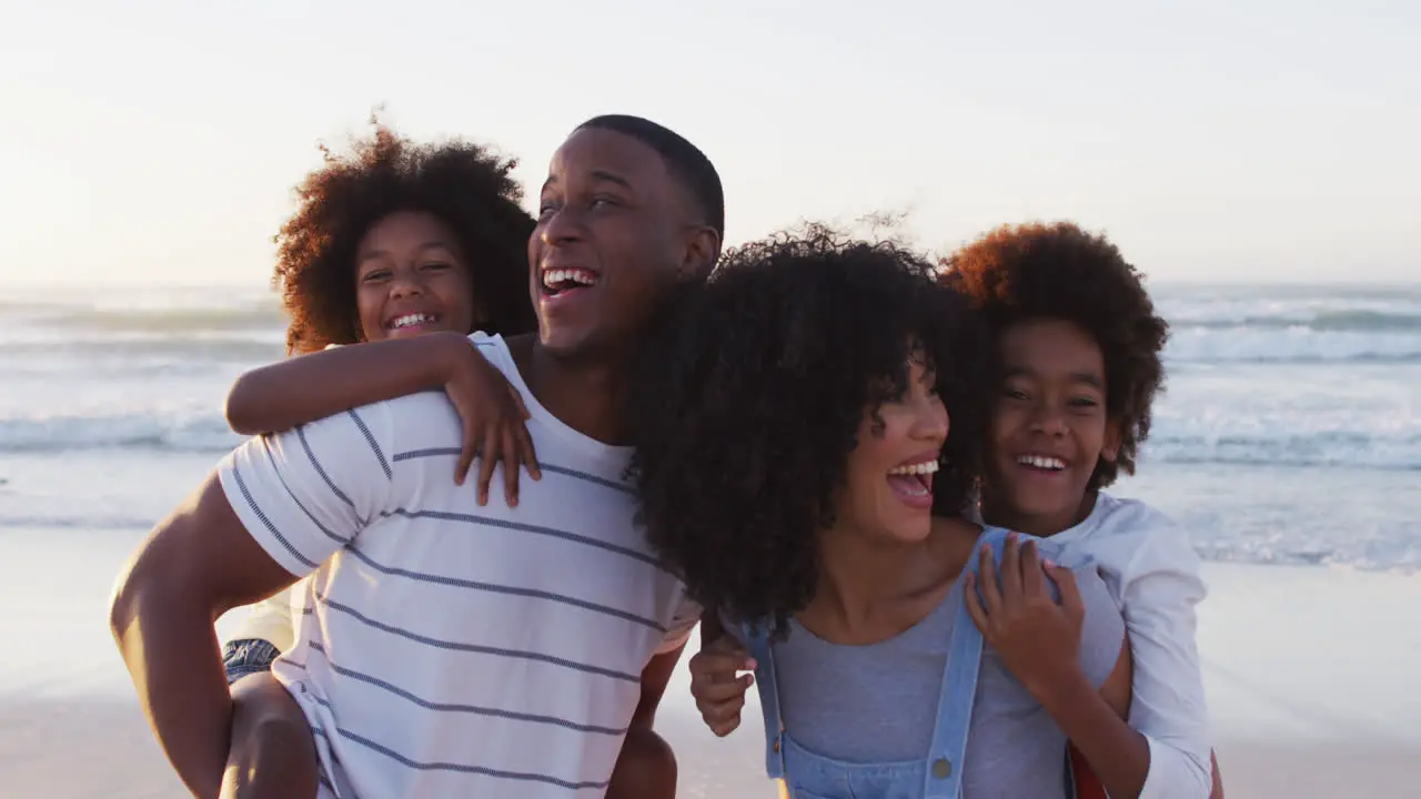 Portrait of african american family smiling together at the beach