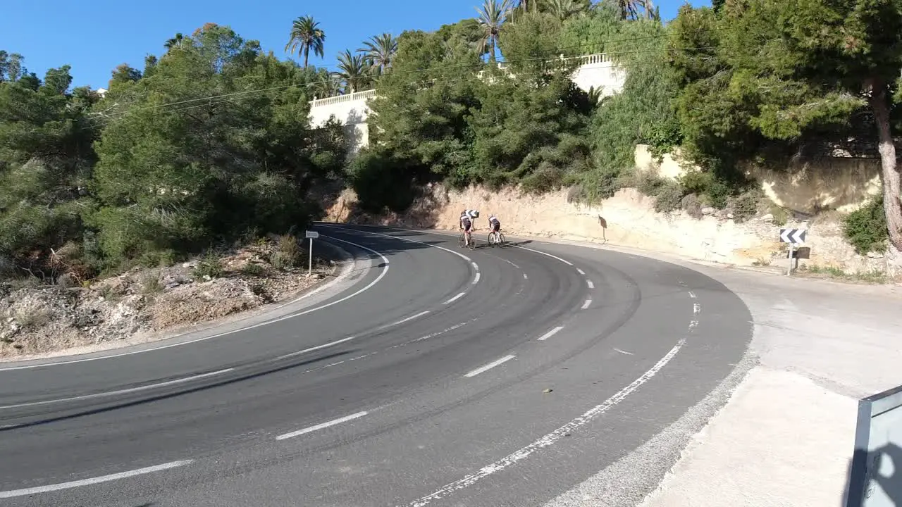 Cyclists climbing a hill in Calpe Spain winter training