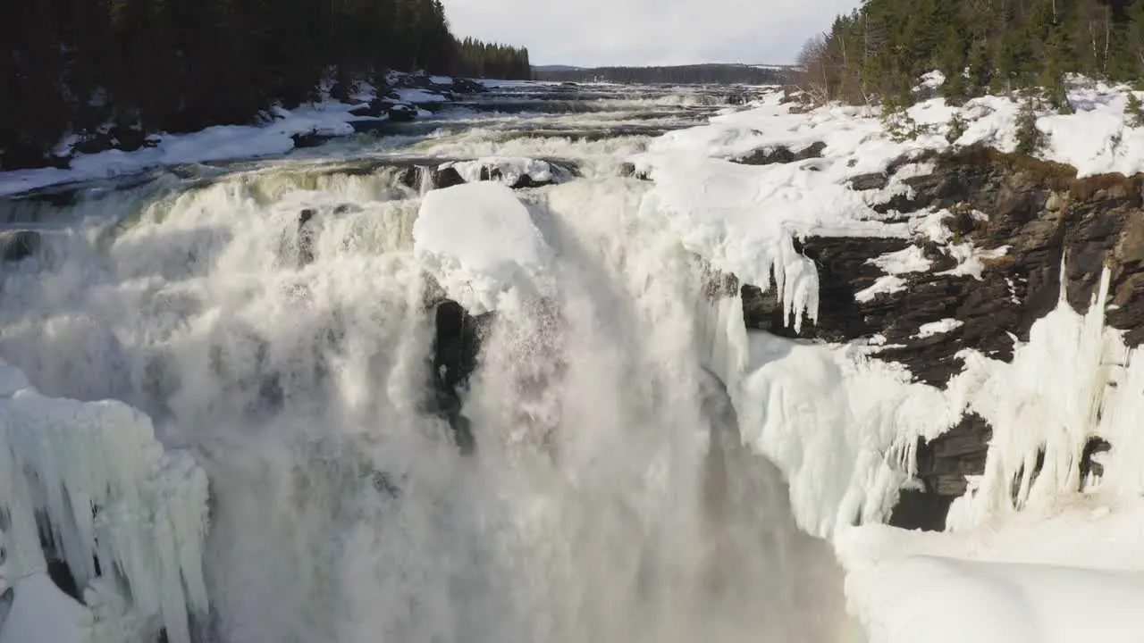 Drone footage of Swedens largest waterfall Tännforsen during spring and flood zooming out from the objective