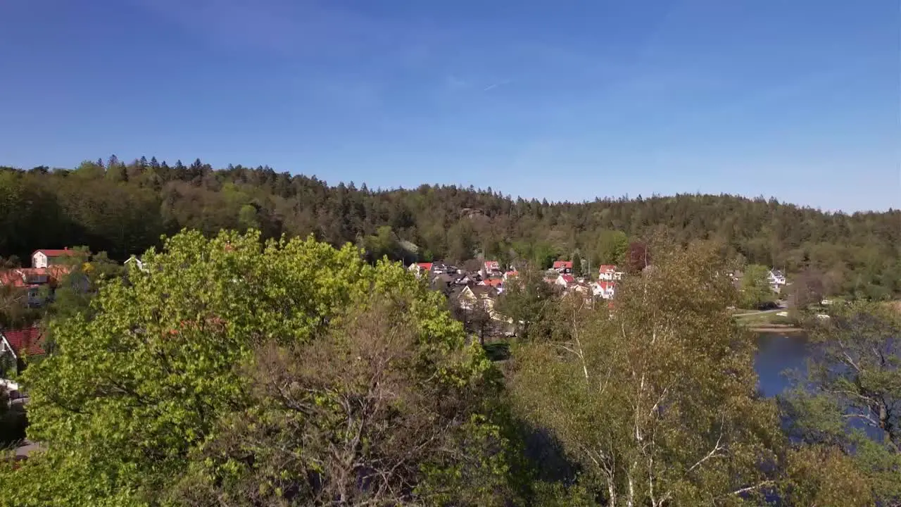 Reveal Drone Shot of a little Village nearby a lake in Sweden