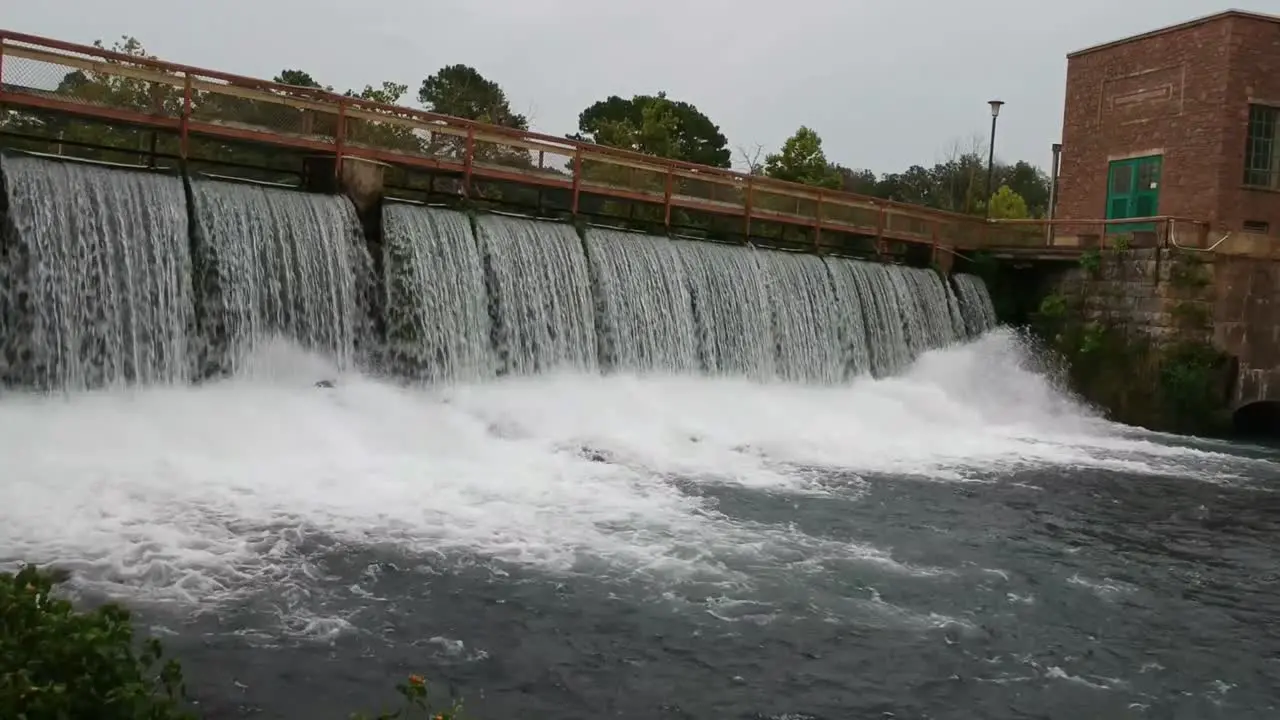 moving towards a dam waterfall drone angle