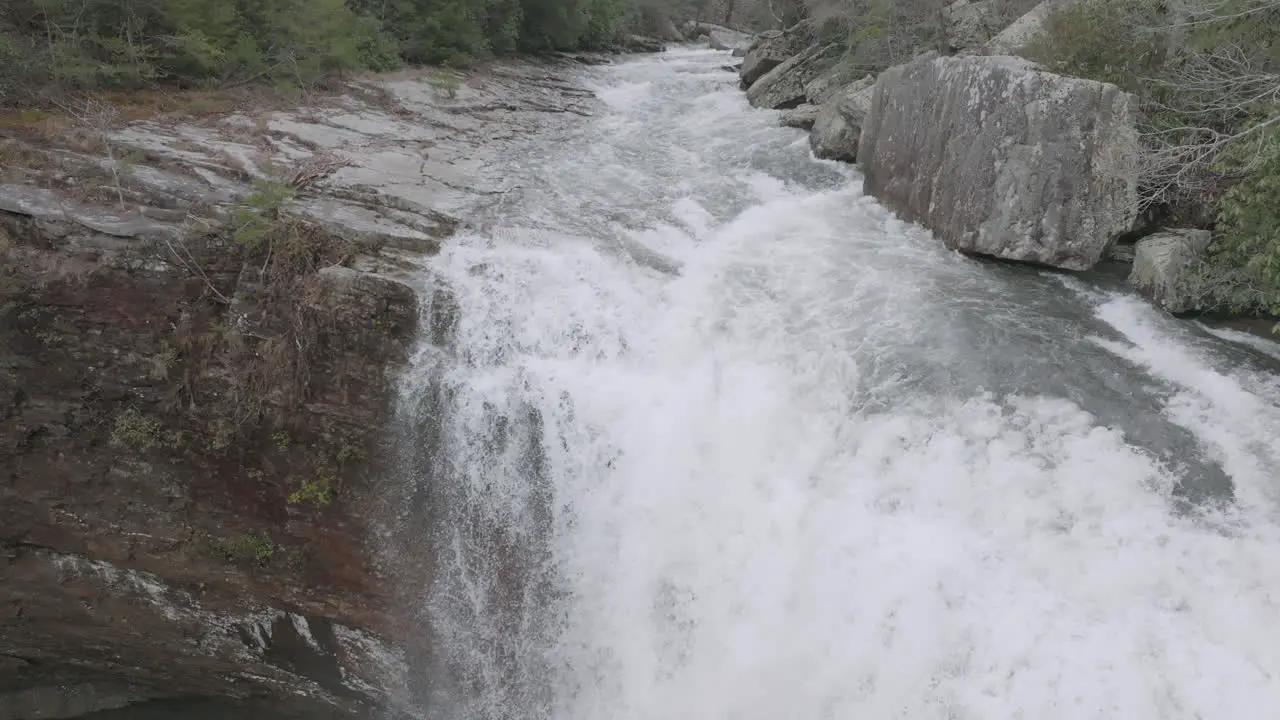 Slow pan down of aerial shot of waterfall