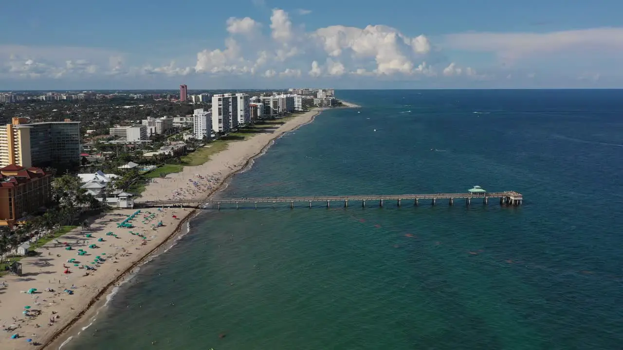 aerial heading towards a pier in the ocean