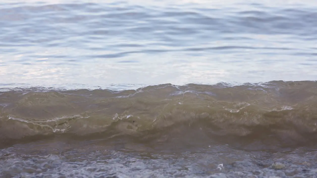 Waves of water lapping at the edge of a lake