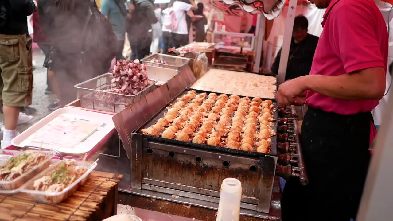 chef skill with chopsticks when cook takoyaki the traditional food from japan