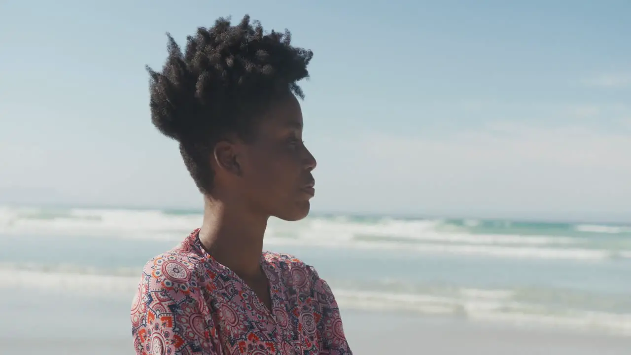 African american young woman enjoying the view at the beach