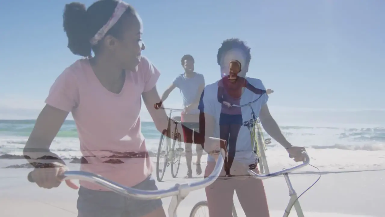 Animation of happy african american couple with bikes over seascape