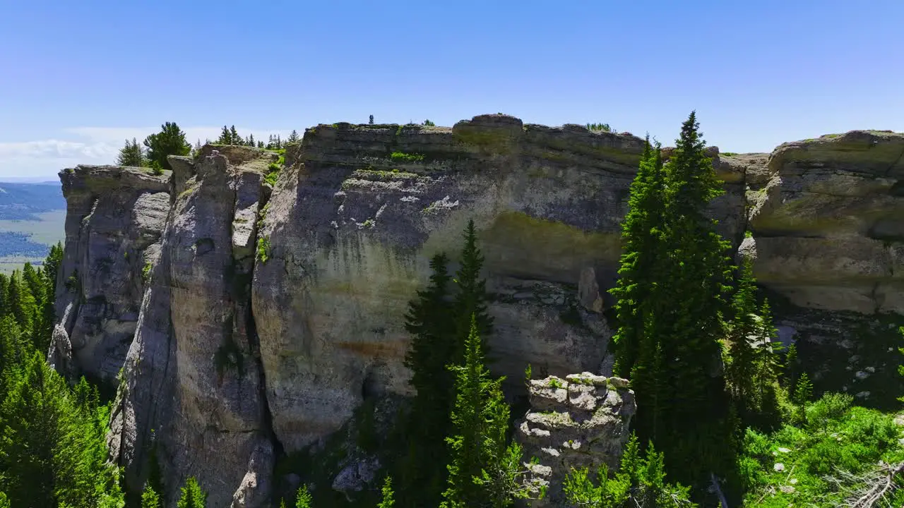 Aerial view of an interesting rock formation with green vegetation and trees around it