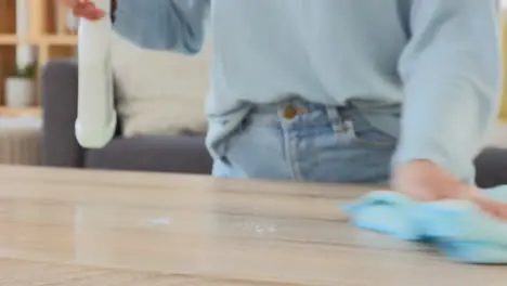 Woman wiping a table at home