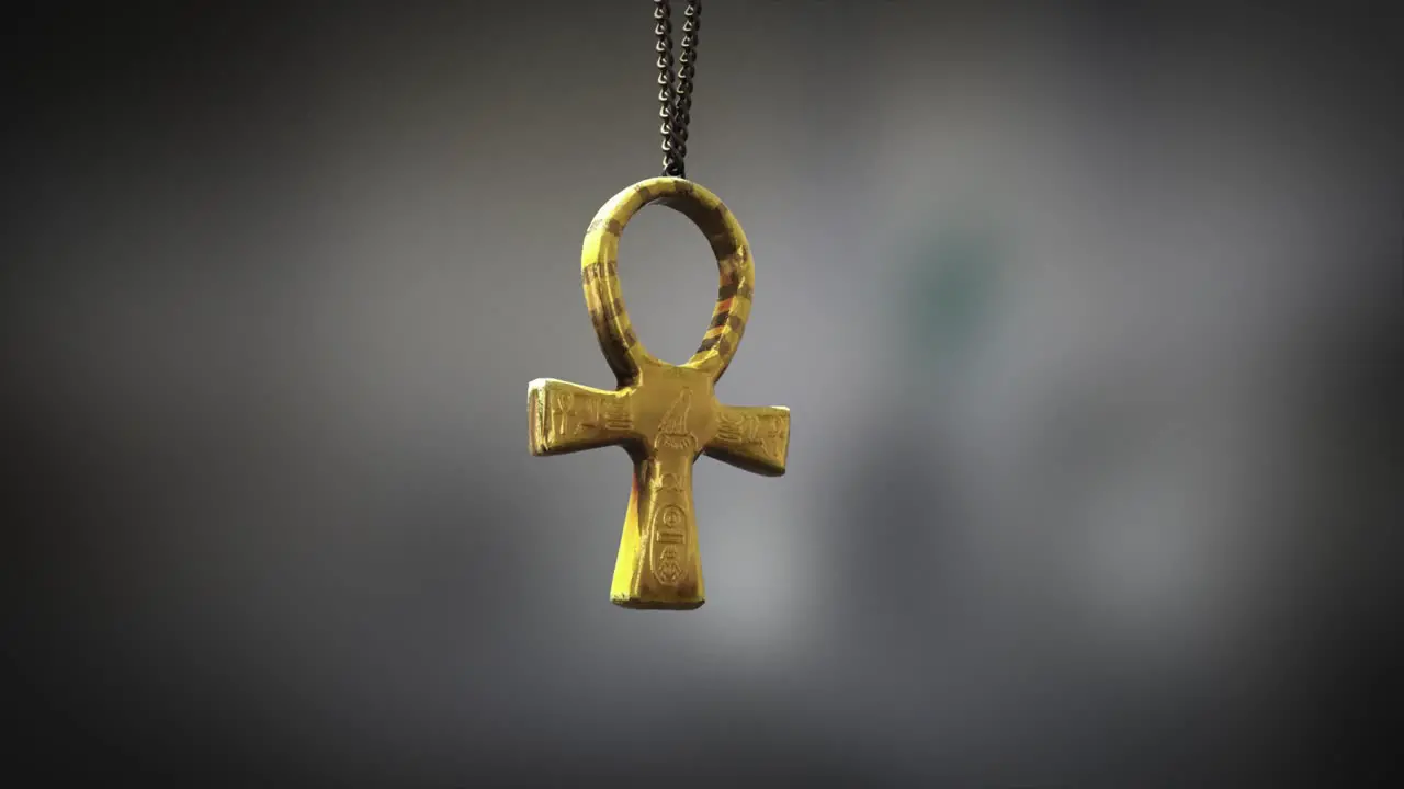 High quality close up render of a beautiful antique gold Egyptian Ankh artifact swinging slowly on the end of a neck chain with super shallow depth of field abd bokeh background