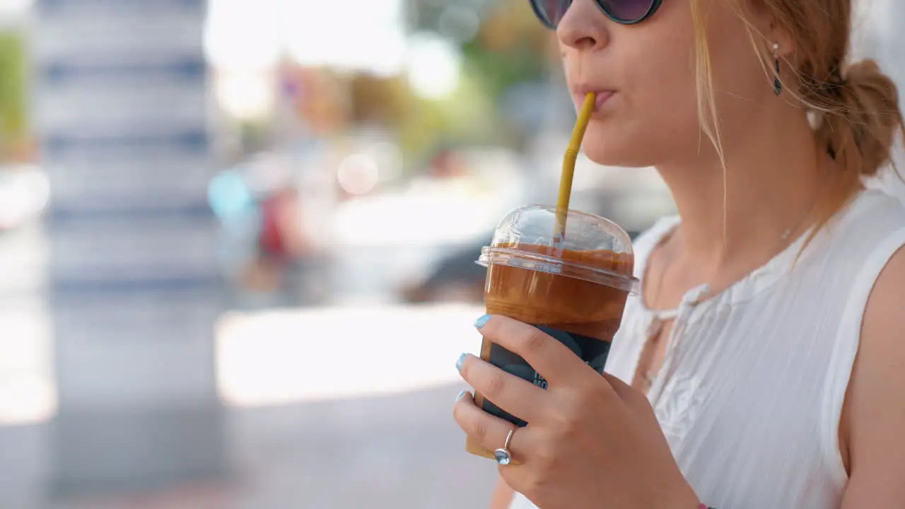 Woman having chocolate drink in the street