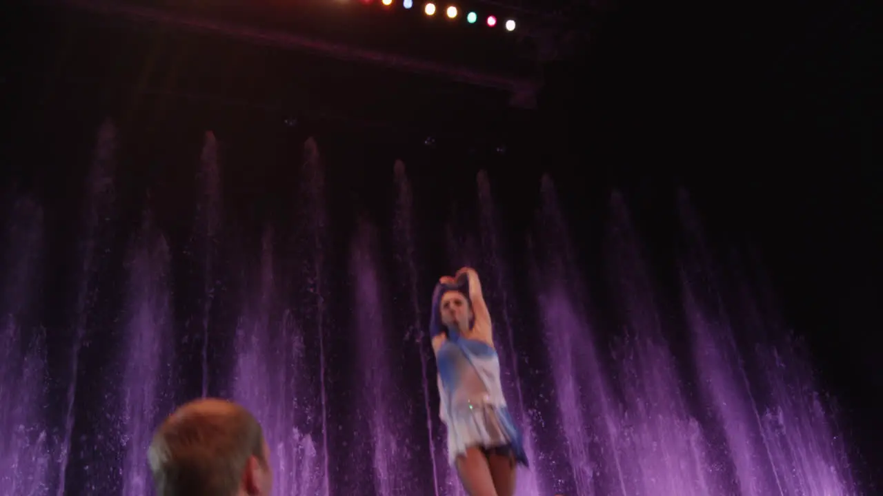 Woman acrobat performing on horizontal bar in the circus