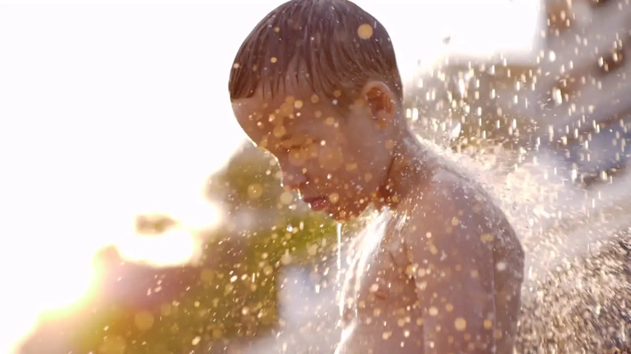 Kid taking beach shower view against sunlight