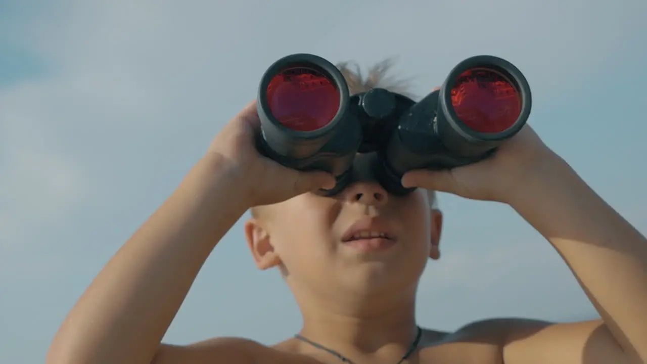 Child exploring the world with binoculars