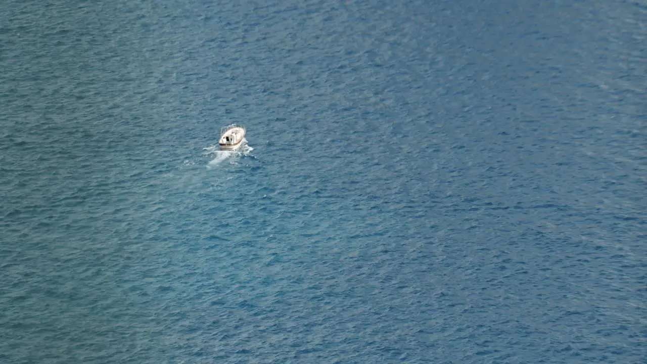 A lonely boat is sailing in the middle of the sea in Capri in Italy