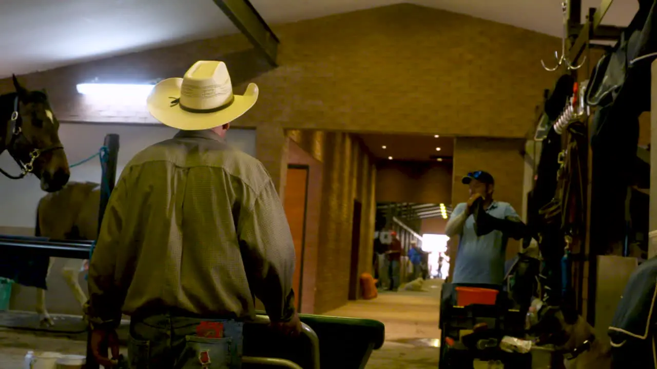 A Mexican groom walks through the extensive stables at a show jumping competition