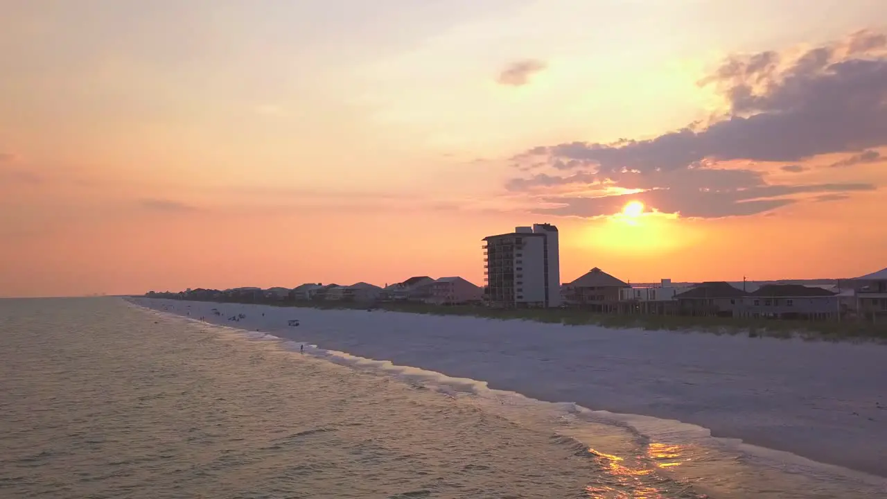 A dramatic aerial shot of the sunset on the beach with striking colors