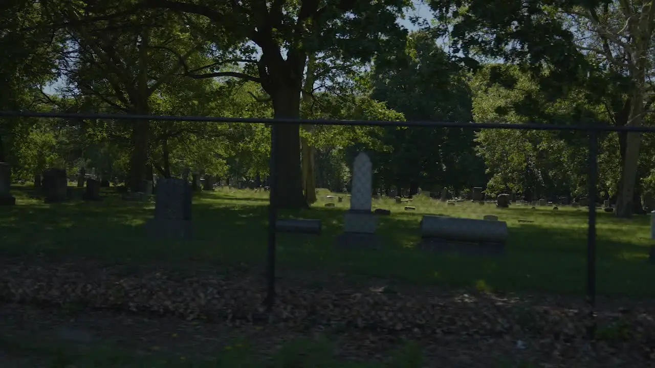 Panning shot of fence with Lake View Cemetery in the background