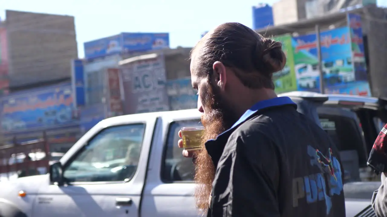 Pakistani Male With Long Beard Slowly Sipping Beverage In Street In Quetta