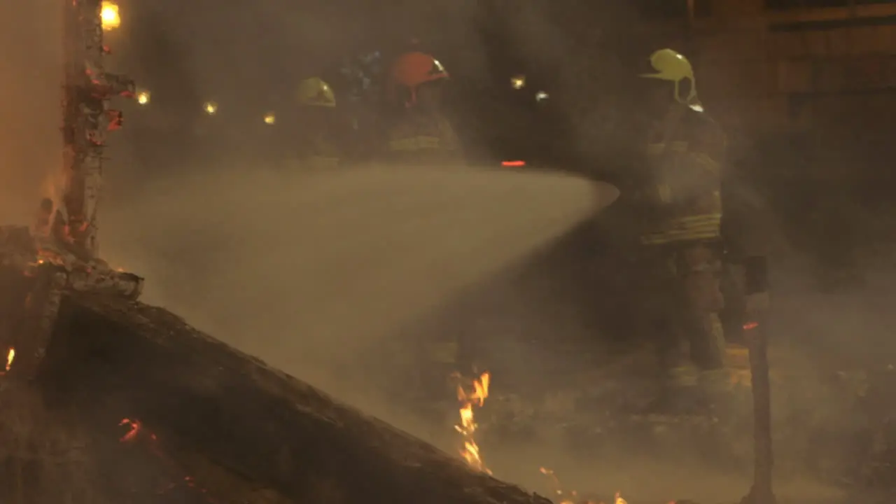 Firemen fighting fire with water