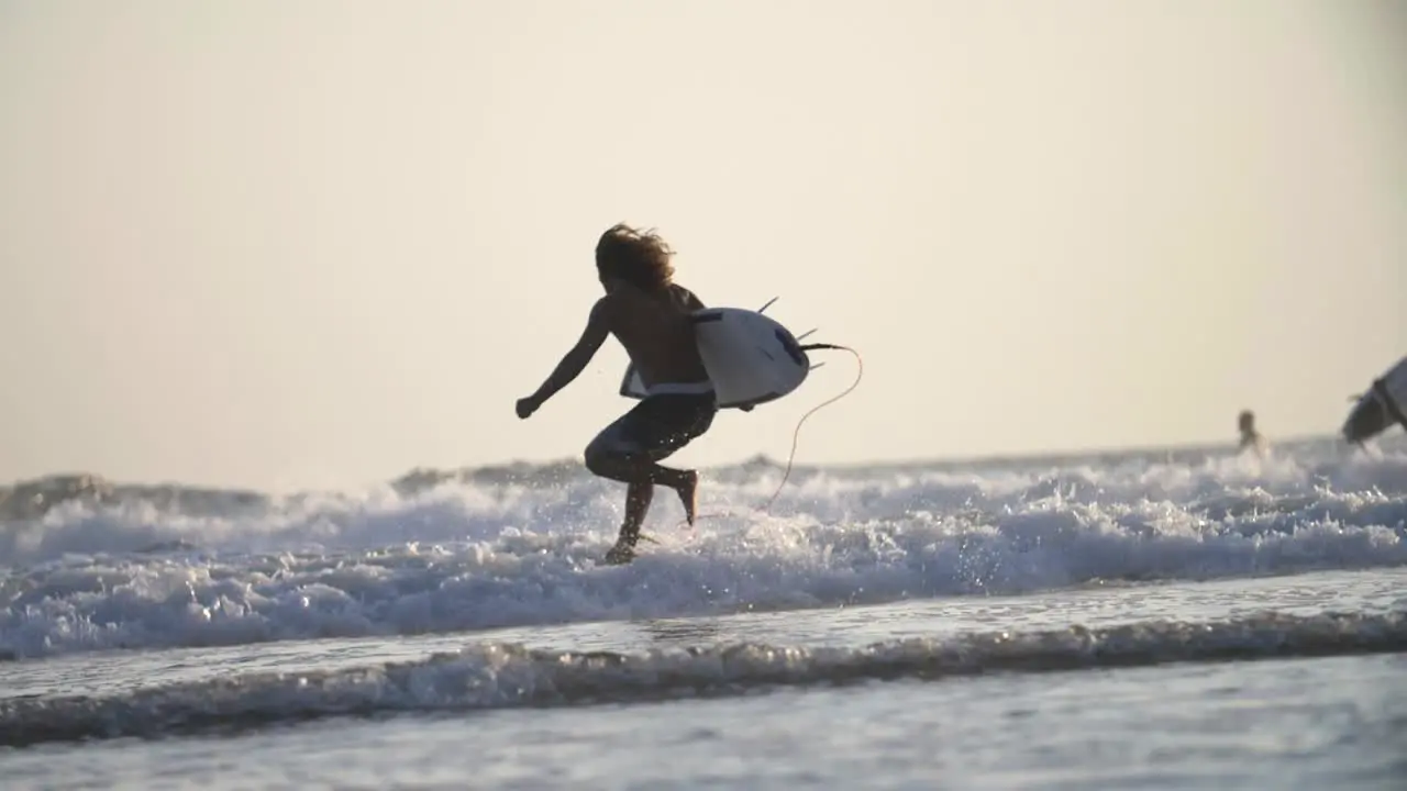 Surfer Running into the Ocean