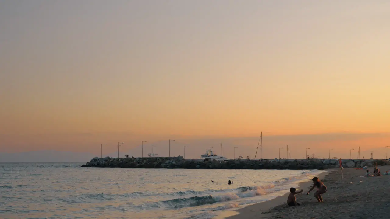 Children playing on the beach Resort scene at sunset