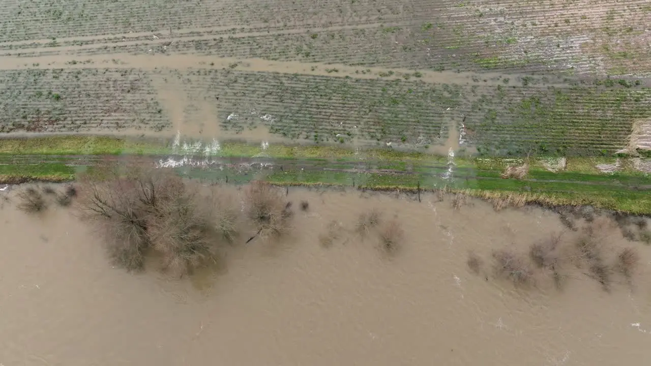 Floodwater from river Waal running over bank onto surrounding farm land