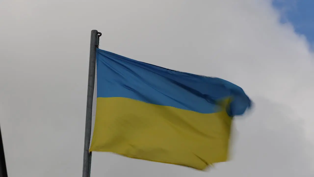 Dynamic Ukrainian Flag Fluttering in the Breeze Against a Cloudy Sky