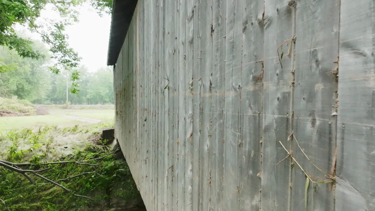 Close-Up Drone View Debris Jammed in Covered Bridge Planks in Flood-Stricken Vermont