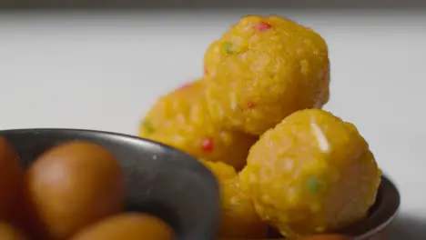 Close Up Of Gulab Jamun And Laddoo In Bowls Celebrating Muslim Festival Of Eid