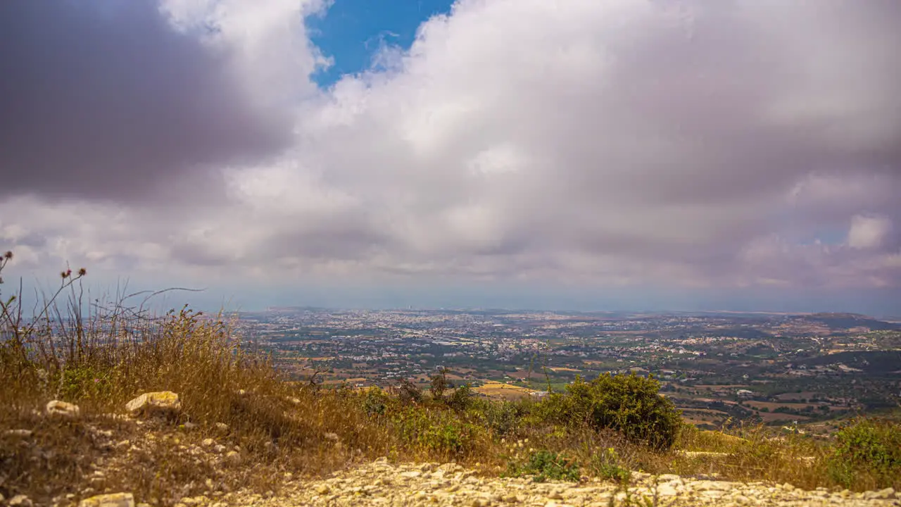 Timelapse of clouds rolling over arid landscape and vista