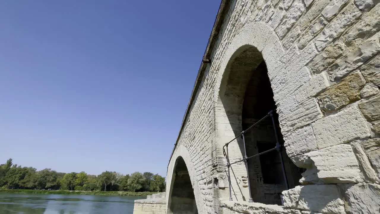 Bridge in Avignon over the river with old chapel made of historic stone arches in good weather