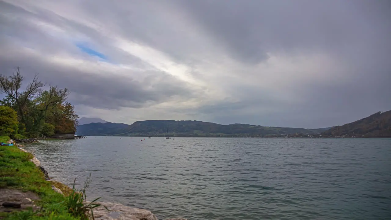 Timelapse clip of a lake with moving clouds above it in the day time