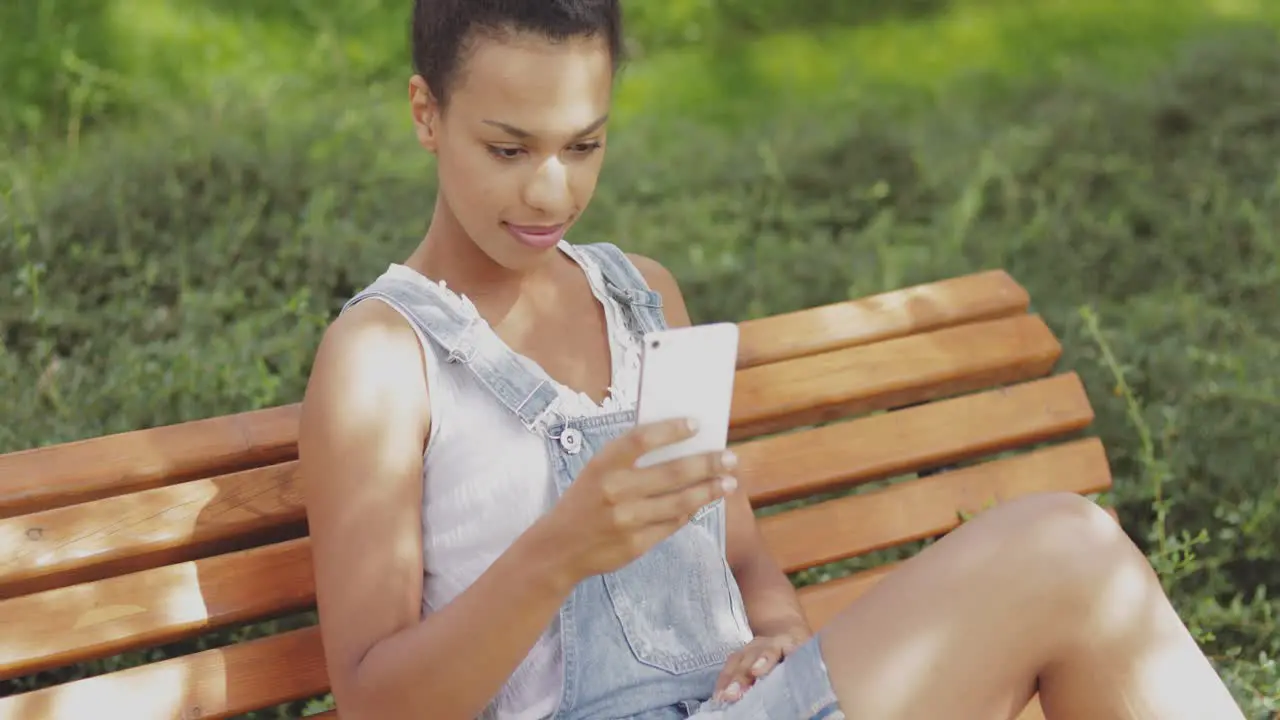 Model taking selfie on bench