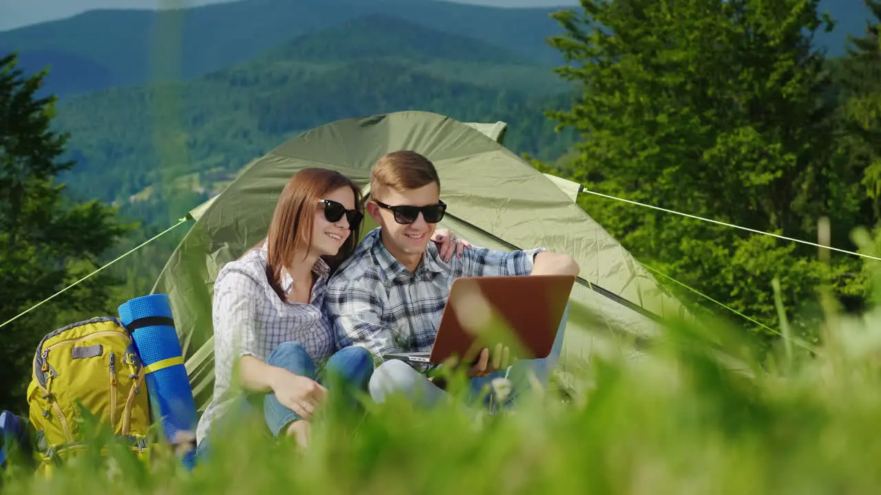 Young People Are Resting In The Campsite And They Use Laptops