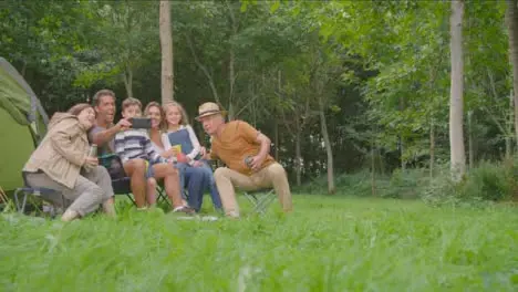 Low Angle Shot of Family Taking Selfie On Camping Trip 01