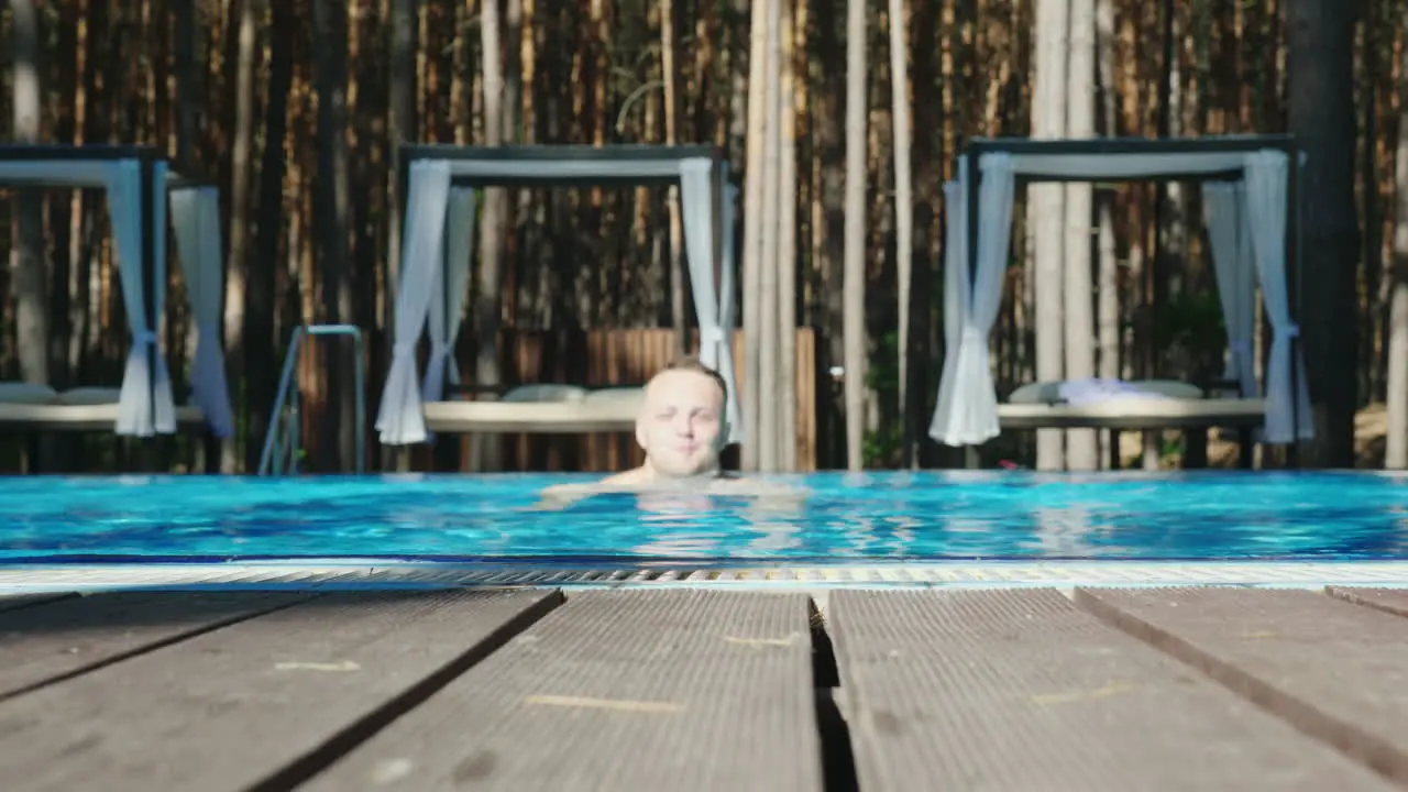 A Man Emerges From The Pool Happy On Vacation