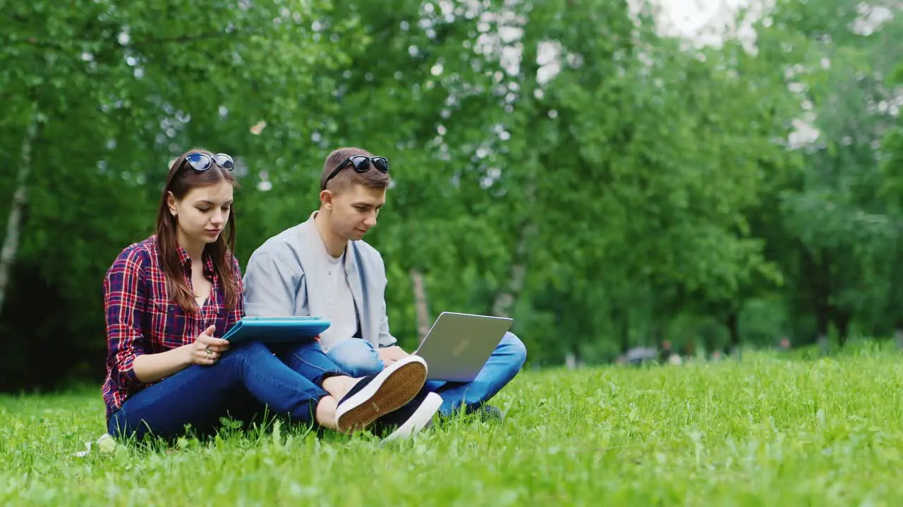 College Students Studying Together In Nature Enjoy Your Tablet And Laptop Hd Video