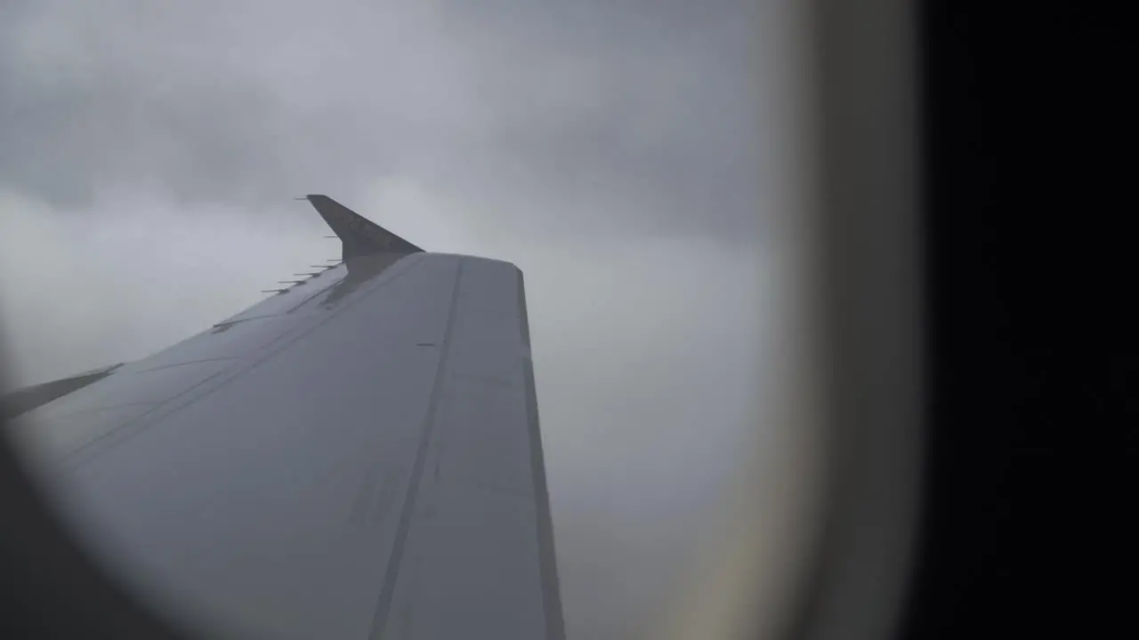 flying airplane and wings cutting through the clouds