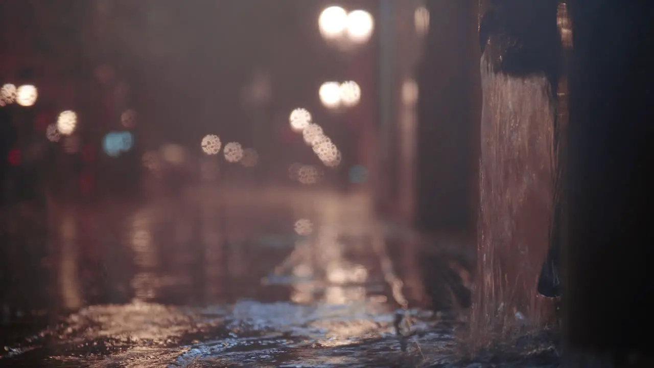 Street downpipe with water pouring after heavy night rain