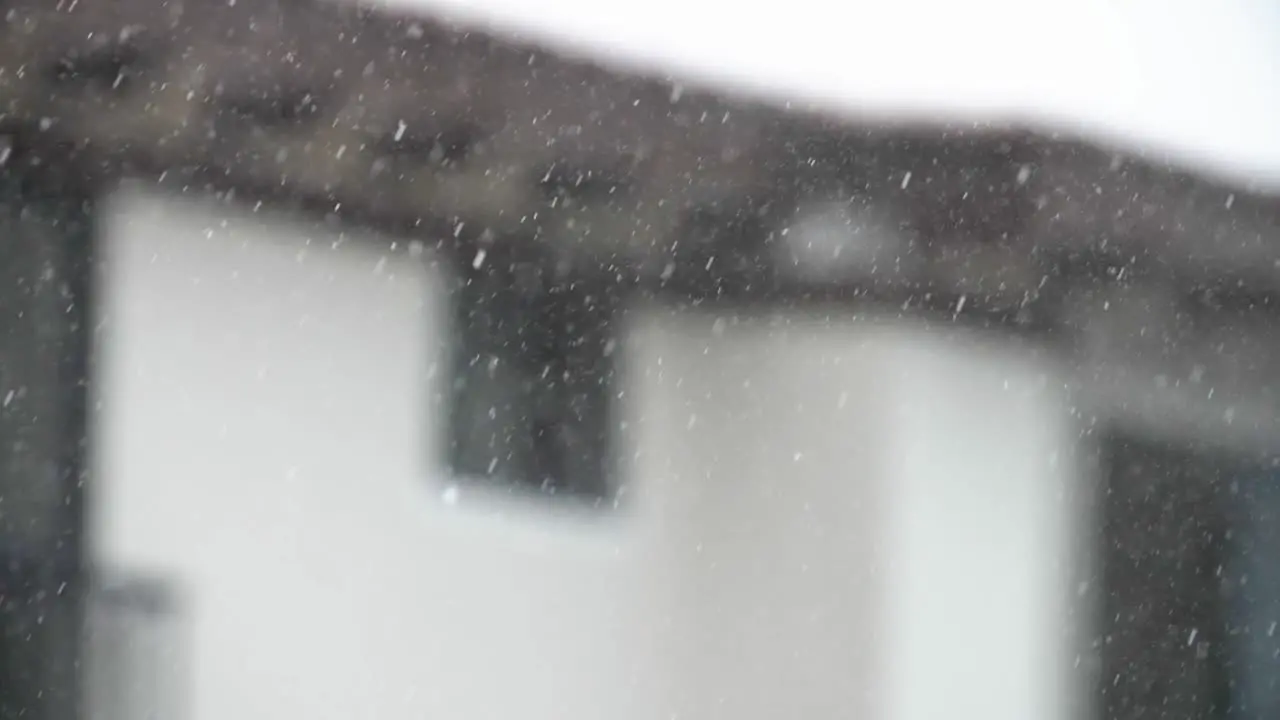 Rain falling in front of a house in a suburban setting Slowmotion