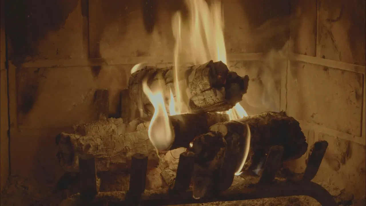 A video of wood burning in a fireplace with flames and crackling sounds