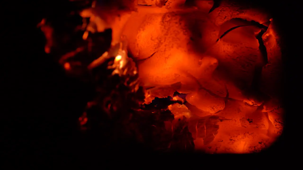 Beautiful hot burning embers in a fireplace sparking and moving