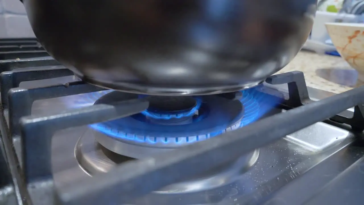 turn up the fire of gas stove range in kitchen