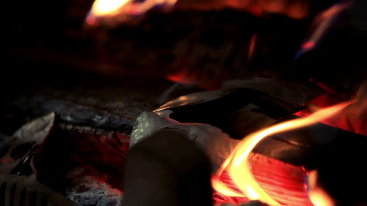 Hot red coals lie in bonfire Firewood burns in red flames fire